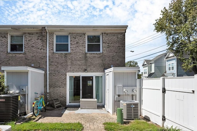 back of property featuring central AC