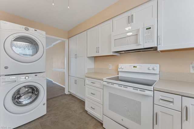 kitchen with white cabinets, white appliances, and stacked washer and dryer