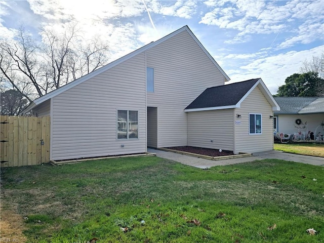 rear view of house with a lawn