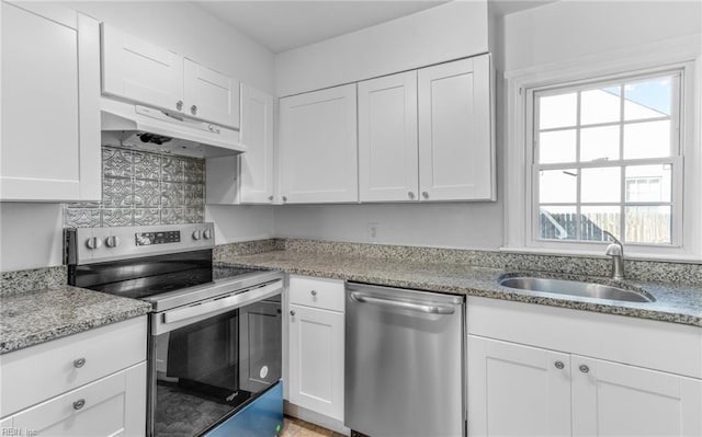 kitchen with backsplash, sink, white cabinets, and stainless steel appliances