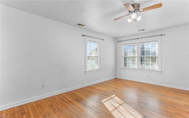 spare room with ceiling fan and light wood-type flooring