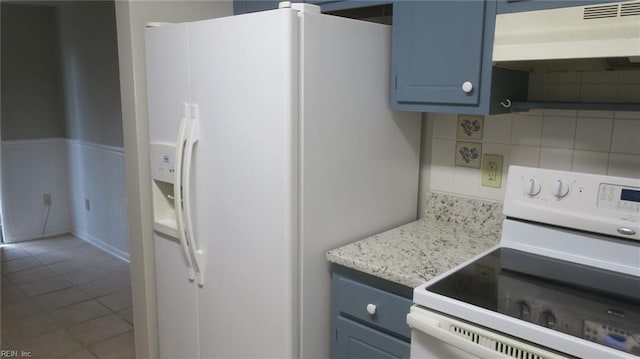 kitchen featuring white appliances, backsplash, blue cabinets, tile patterned flooring, and range hood