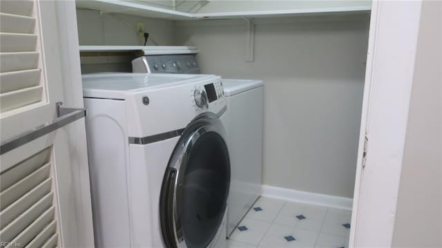 clothes washing area with washer and clothes dryer