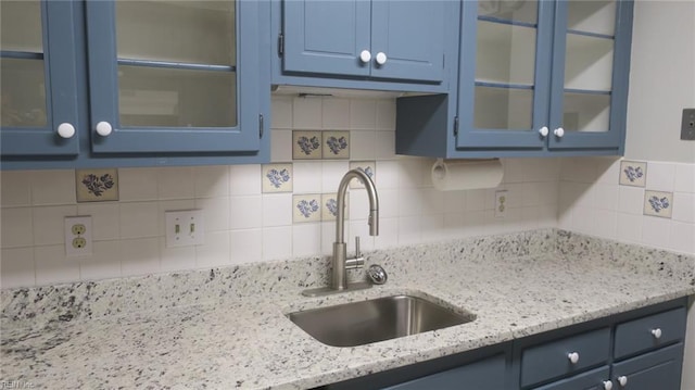 kitchen with blue cabinetry and sink