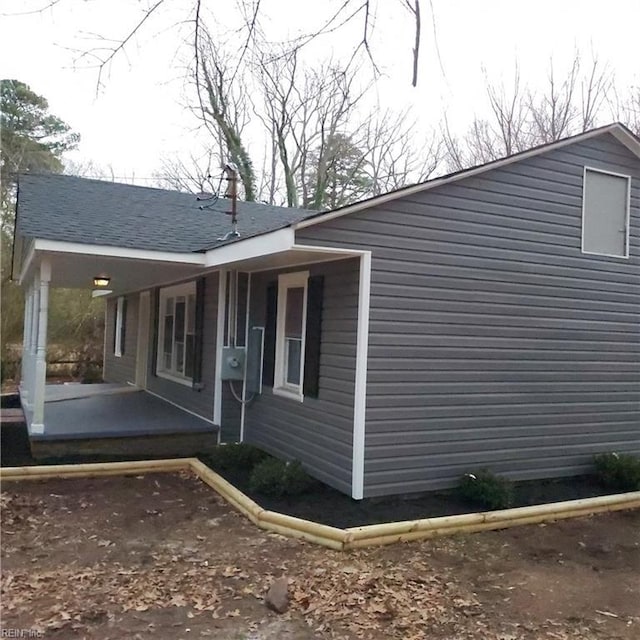 view of property exterior featuring covered porch