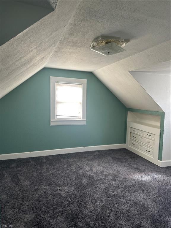 bonus room featuring carpet floors, a textured ceiling, and vaulted ceiling