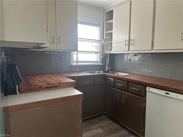 kitchen featuring dishwasher, backsplash, sink, dark hardwood / wood-style floors, and butcher block countertops