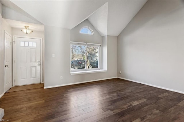 foyer entrance with dark hardwood / wood-style floors, a wealth of natural light, and vaulted ceiling