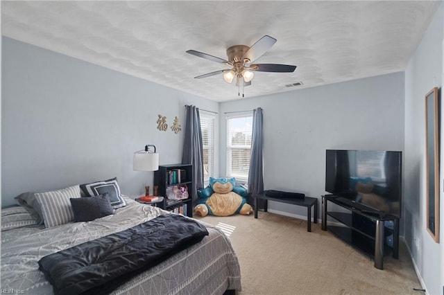 bedroom featuring ceiling fan and light carpet