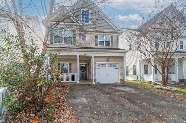 view of front of home featuring covered porch and a garage