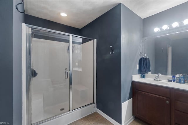 bathroom featuring vanity, tile patterned floors, and a shower with door