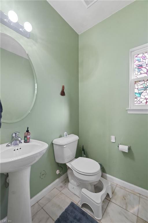 bathroom featuring tile patterned flooring and toilet