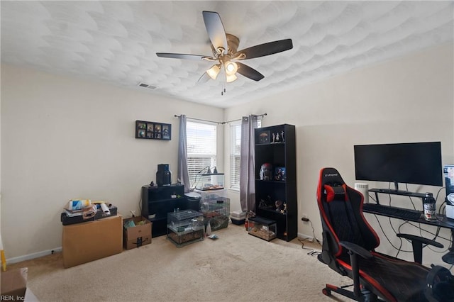 carpeted home office with ceiling fan