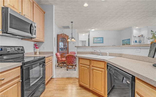 kitchen with pendant lighting, light brown cabinets, black appliances, sink, and light hardwood / wood-style floors