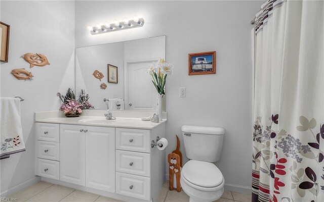 bathroom with curtained shower, tile patterned flooring, vanity, and toilet