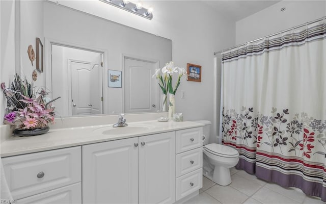 bathroom featuring tile patterned floors, vanity, a shower with shower curtain, and toilet