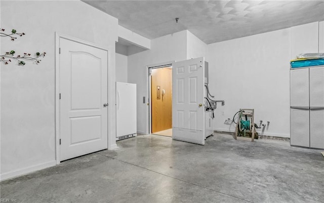 garage featuring white fridge