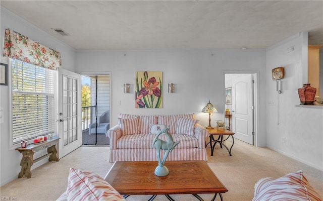 carpeted living room with crown molding and french doors