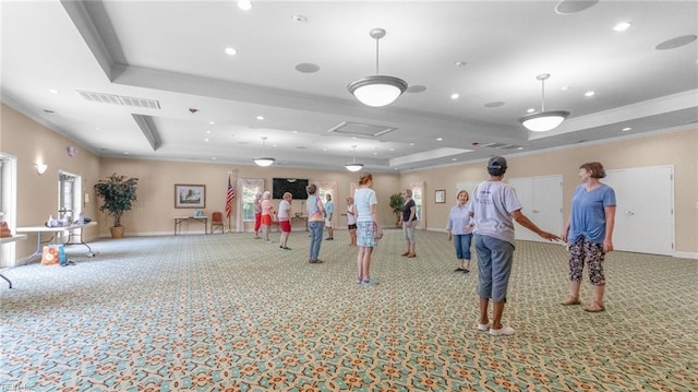 misc room featuring a raised ceiling, crown molding, and carpet