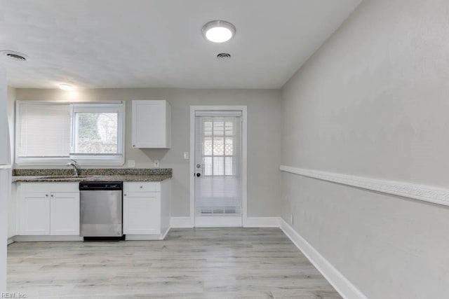 kitchen featuring dishwasher, white cabinets, light hardwood / wood-style floors, and sink