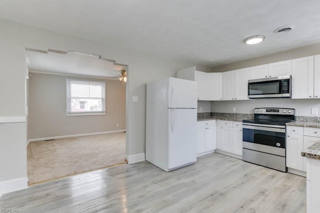 kitchen with white cabinets, ceiling fan, light wood-type flooring, and stainless steel appliances