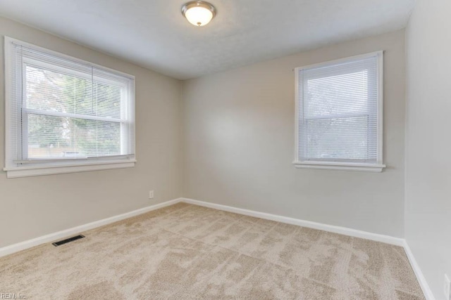 empty room featuring light colored carpet