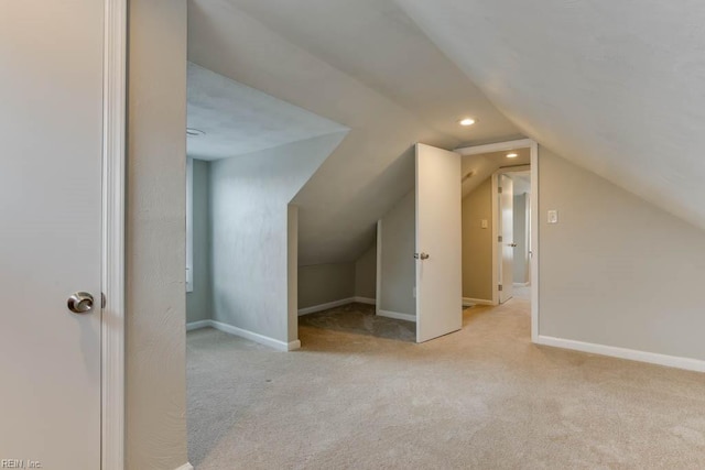 bonus room featuring light colored carpet and lofted ceiling