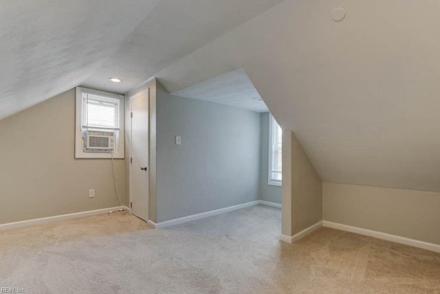 bonus room with light carpet, vaulted ceiling, and cooling unit