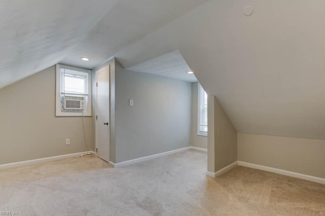 additional living space with light colored carpet, vaulted ceiling, and cooling unit