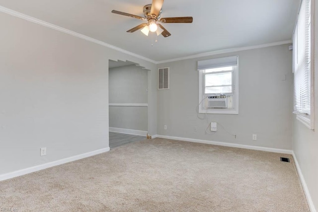 carpeted spare room featuring ceiling fan and ornamental molding