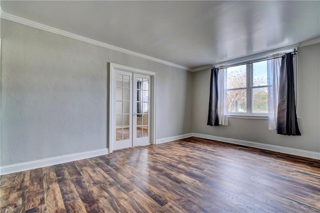 empty room featuring crown molding, french doors, and dark wood-type flooring