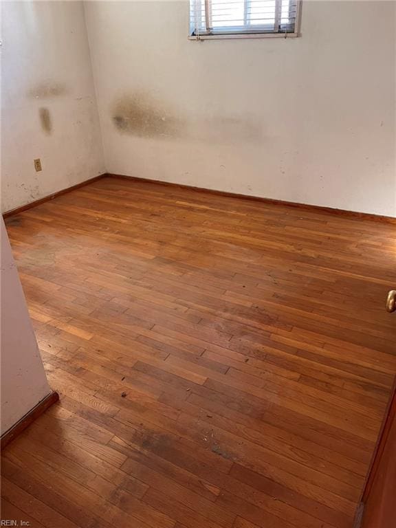 empty room featuring wood-type flooring