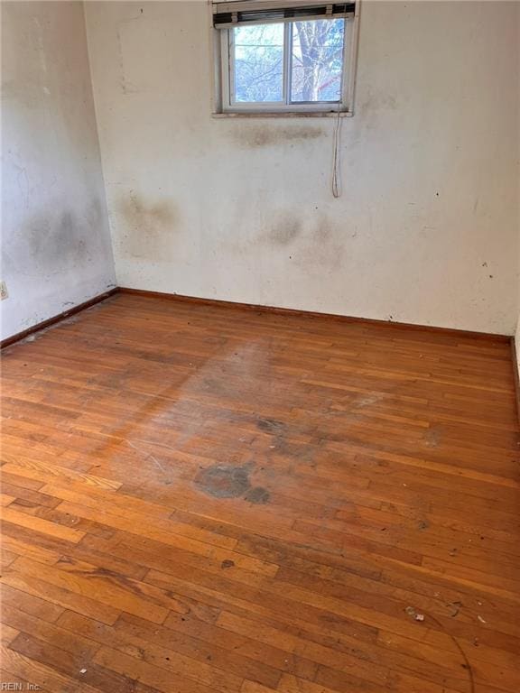 spare room with hardwood / wood-style flooring