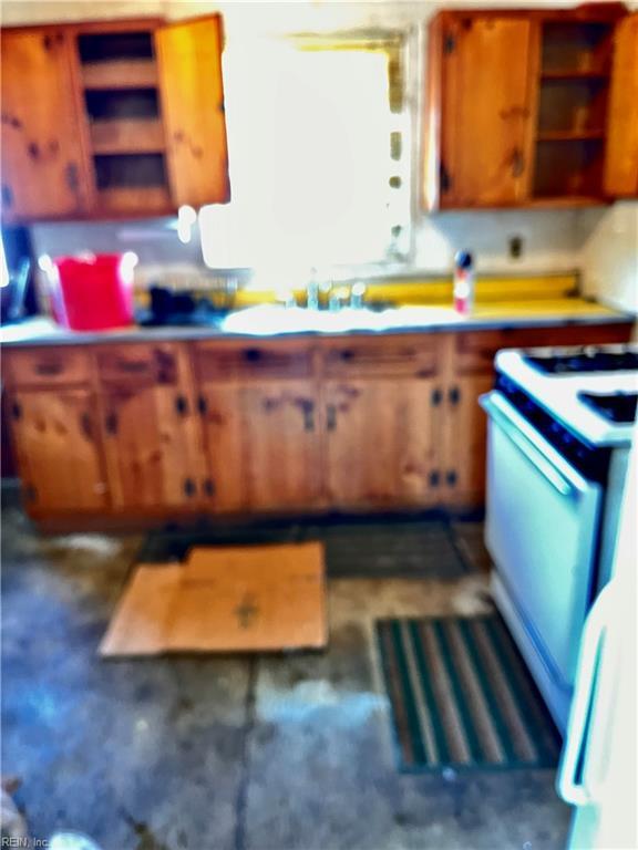 kitchen featuring white electric stove and sink