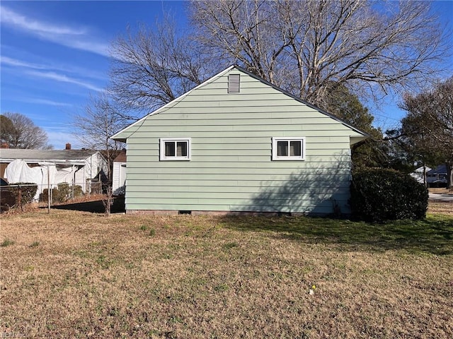 view of side of property with a lawn