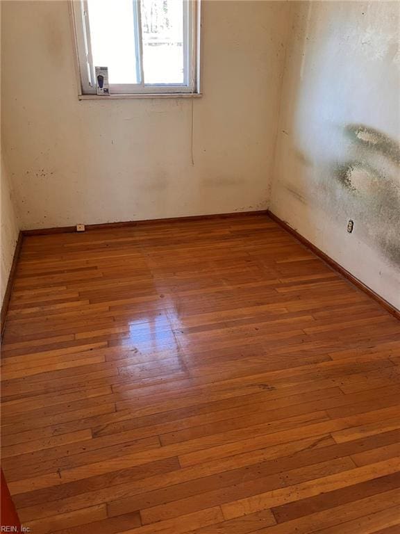 spare room with hardwood / wood-style flooring