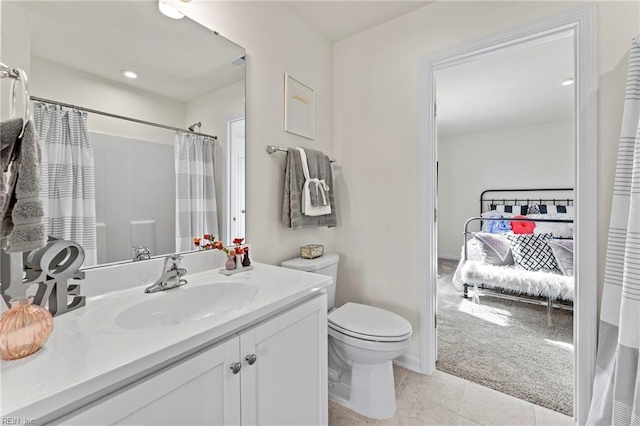 bathroom with curtained shower, tile patterned flooring, vanity, and toilet