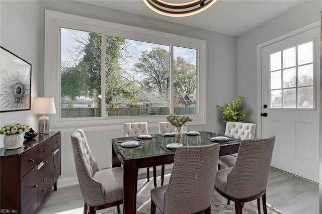 dining area with light wood-type flooring and a wealth of natural light