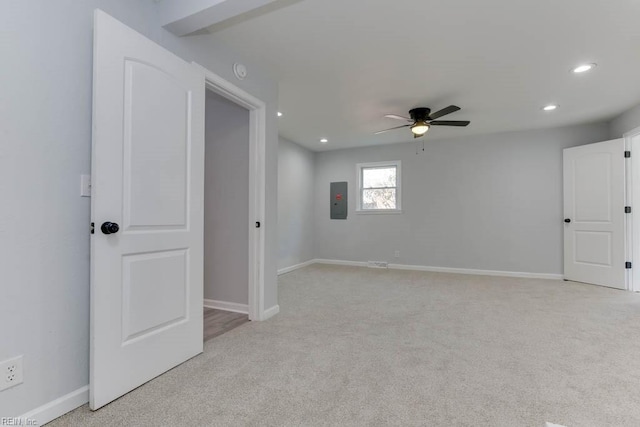 carpeted empty room featuring electric panel and ceiling fan