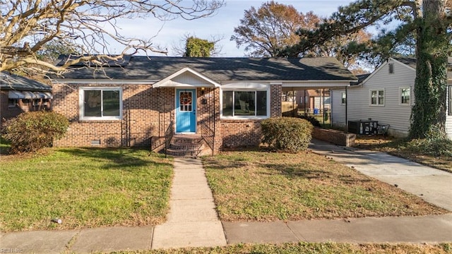 view of front of property with a front yard, central AC, and a carport