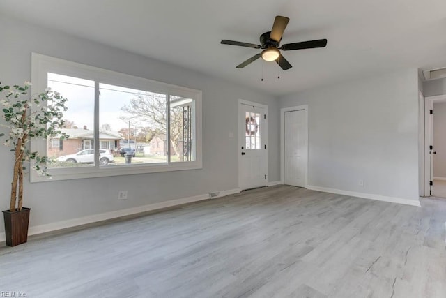 unfurnished living room featuring ceiling fan, a healthy amount of sunlight, and light hardwood / wood-style flooring