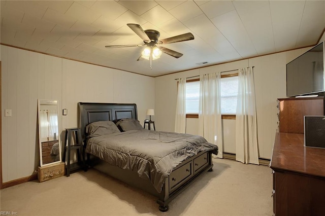 bedroom with ceiling fan, crown molding, and light colored carpet