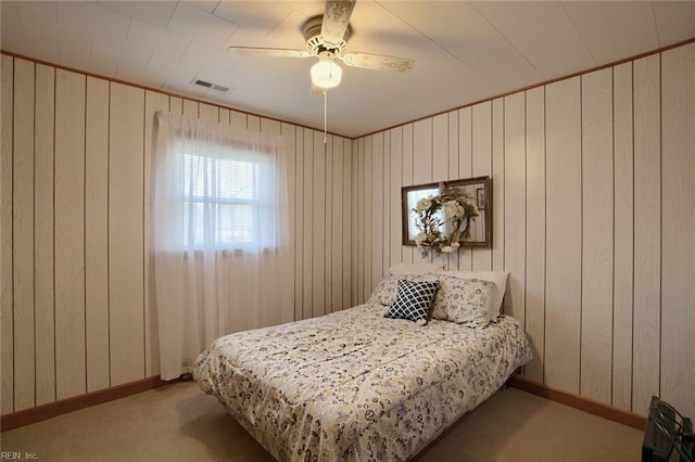 bedroom with ceiling fan and light carpet