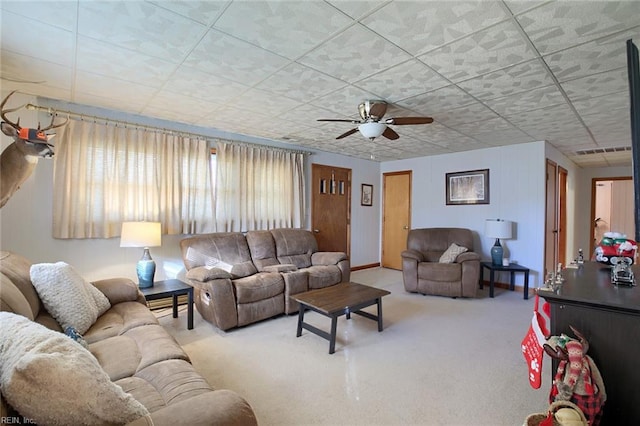 carpeted living room with ceiling fan