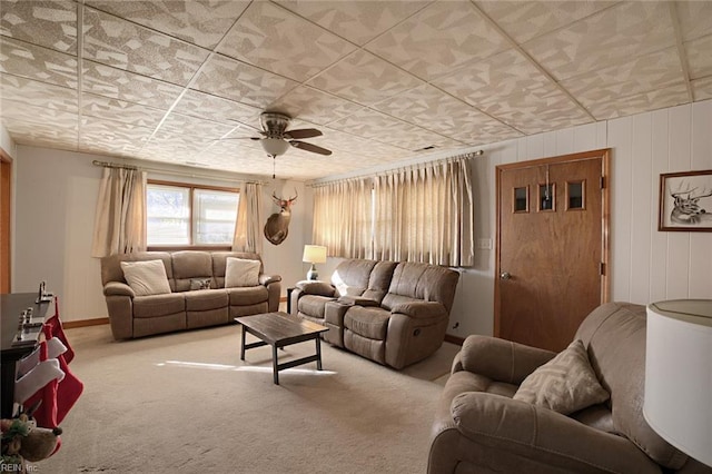 carpeted living room with ceiling fan