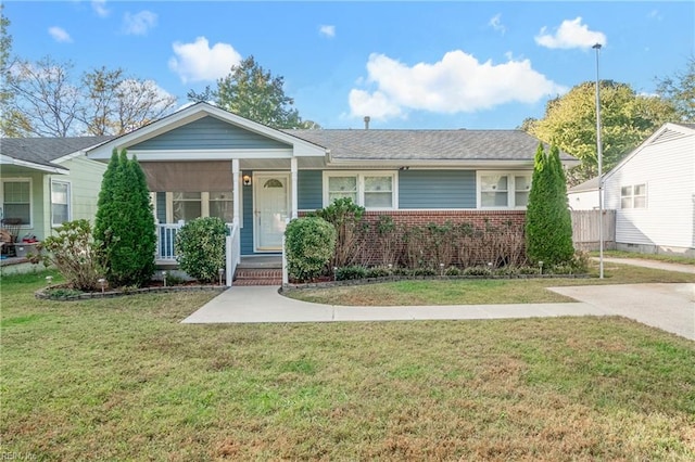 single story home with a porch and a front yard