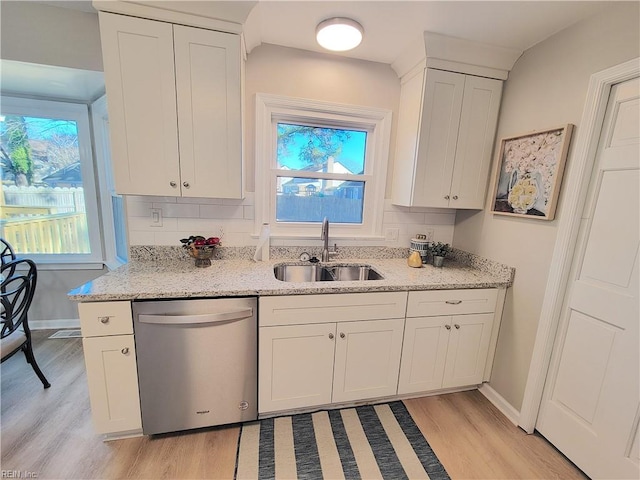 kitchen with dishwasher, light wood-type flooring, white cabinetry, and sink