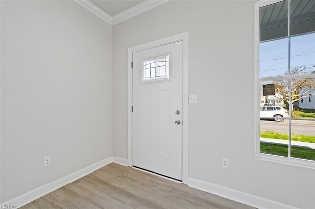 foyer entrance with crown molding and light hardwood / wood-style flooring