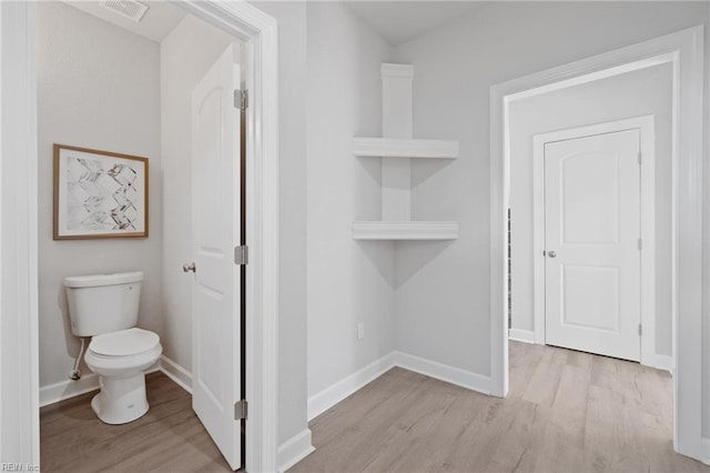 bathroom featuring hardwood / wood-style floors and toilet