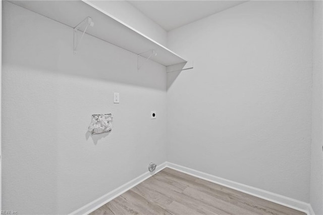 laundry room with hookup for an electric dryer and wood-type flooring